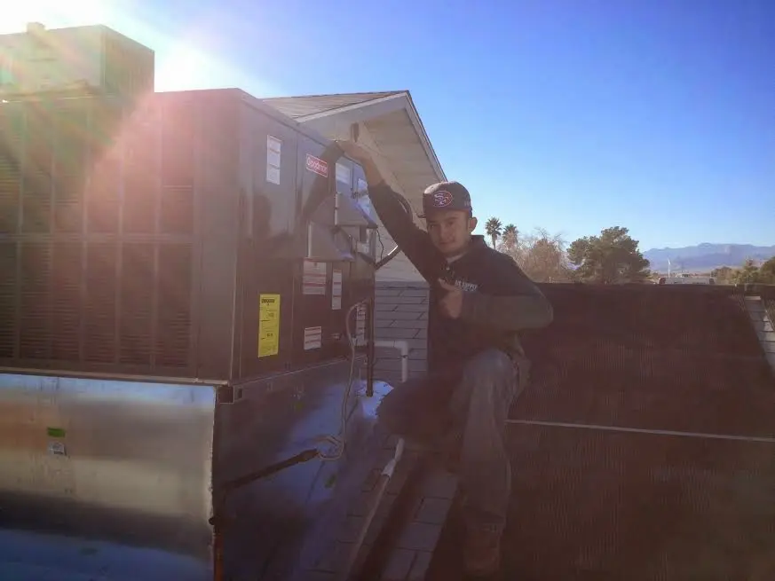 HVAC technician performing Heat Pump Repair on a rooftop unit in Toccoa